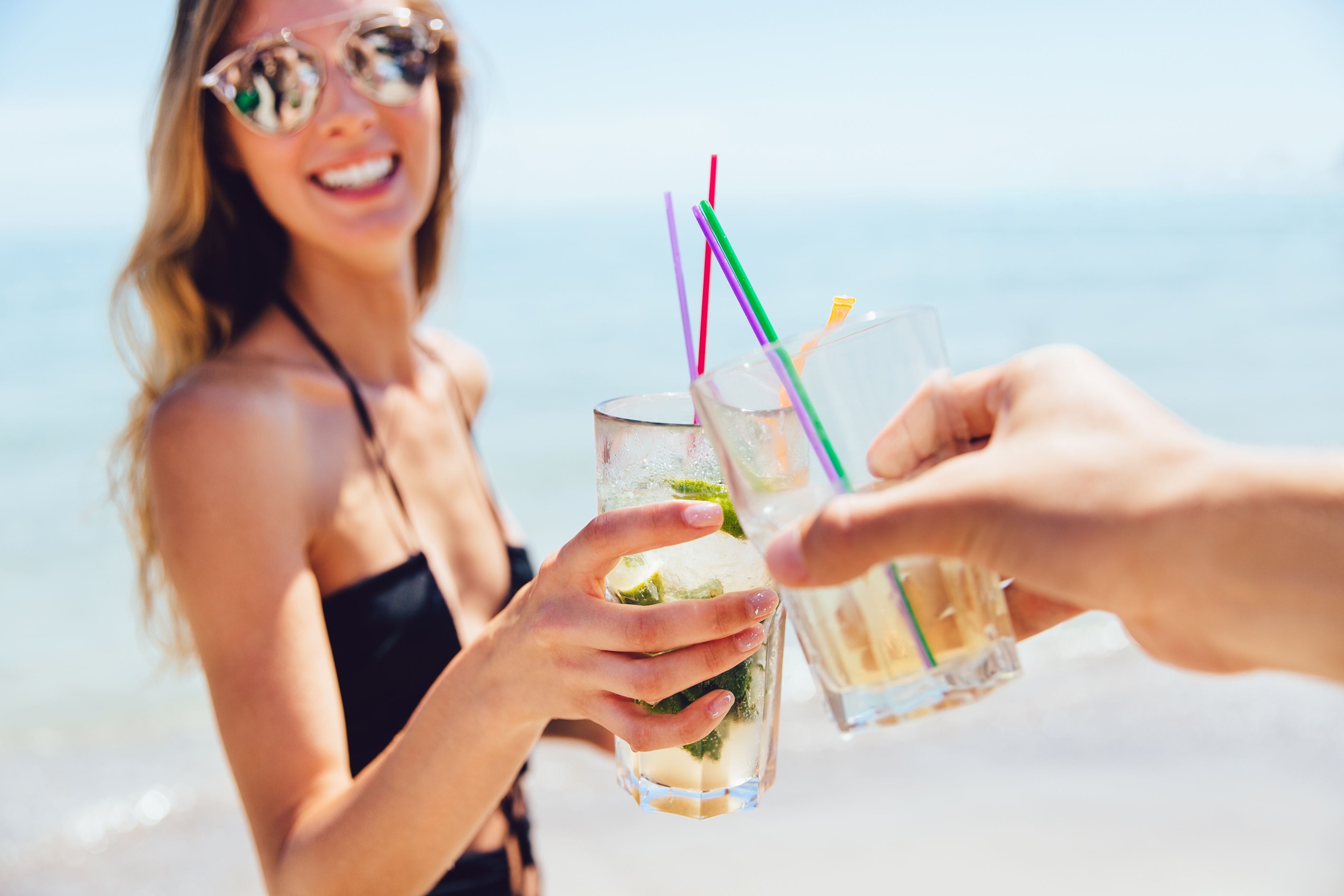 joyful-attractive-woman-sunglasses-drinking-cocktail-with-friend-toasting